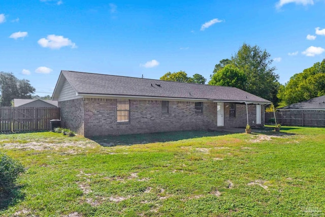 back of house featuring a yard