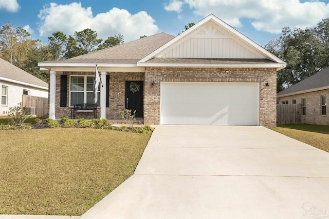 craftsman-style home featuring a front yard, a garage, and covered porch