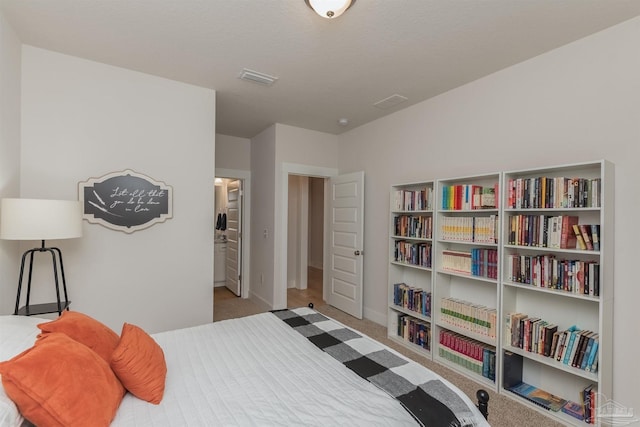 carpeted bedroom featuring connected bathroom