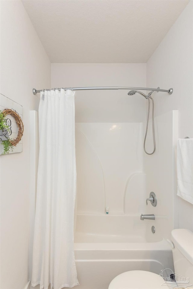 bathroom featuring toilet and shower / tub combo with curtain