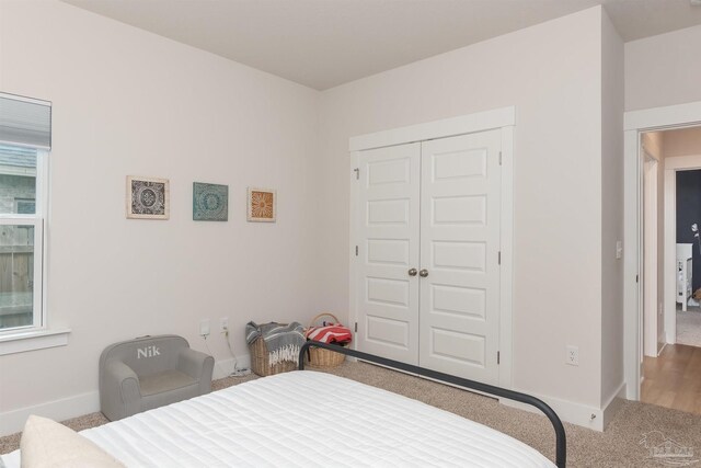 carpeted bedroom featuring a closet