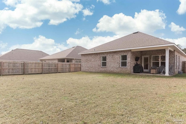 back of house featuring a yard and a patio area