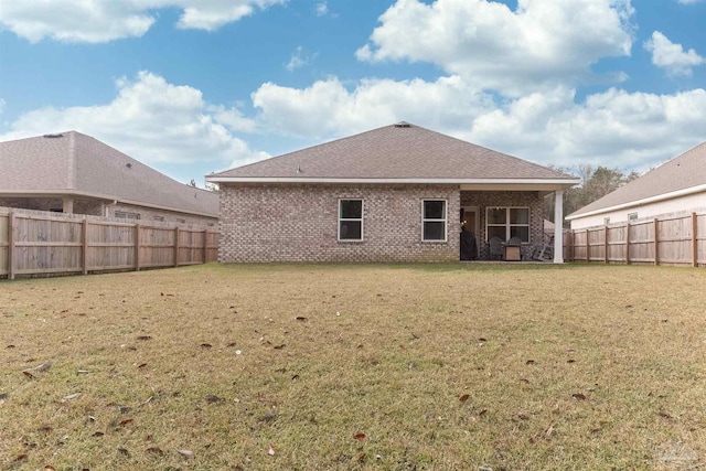 back of house with a lawn