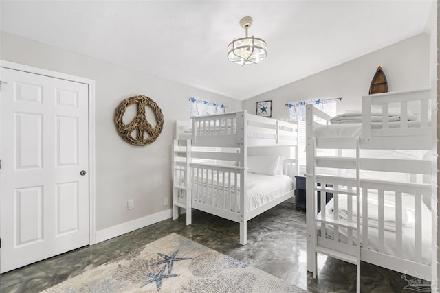 bedroom featuring vaulted ceiling and a notable chandelier