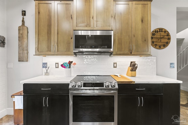 kitchen featuring hardwood / wood-style flooring, backsplash, and appliances with stainless steel finishes