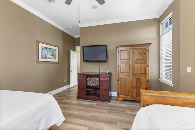 bedroom featuring ceiling fan, light wood-type flooring, and ornamental molding