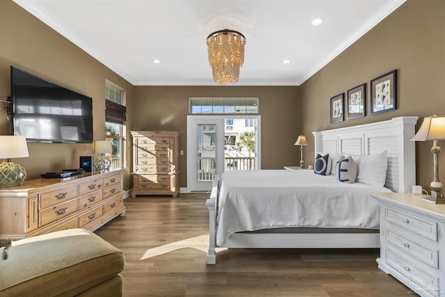 bedroom with access to outside, ornamental molding, dark hardwood / wood-style floors, and an inviting chandelier