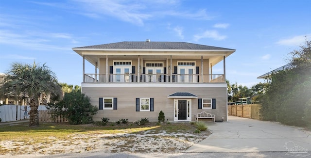 view of front of property with french doors and a balcony