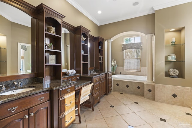 bathroom with tiled bath, ornate columns, tile patterned flooring, and vanity