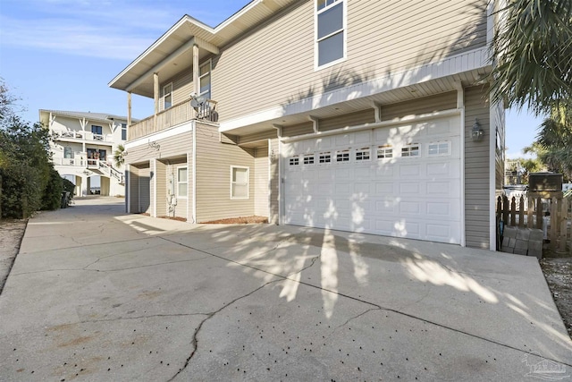 view of side of property with a balcony and a garage