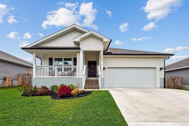 view of front facade with a front yard, a porch, and a garage