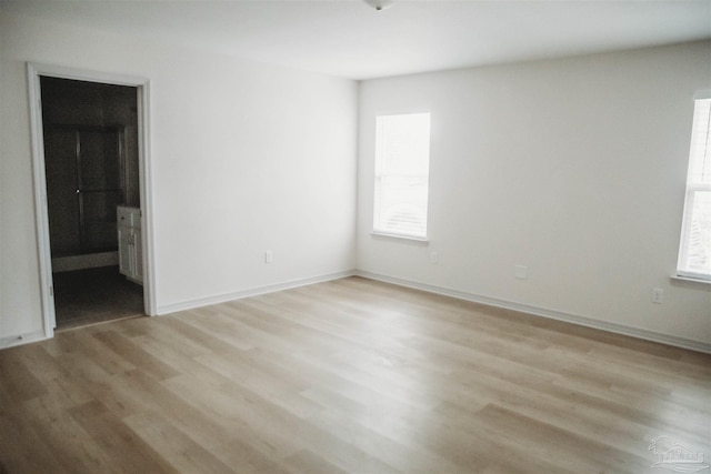 spare room featuring light hardwood / wood-style floors