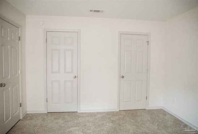 unfurnished bedroom with light carpet