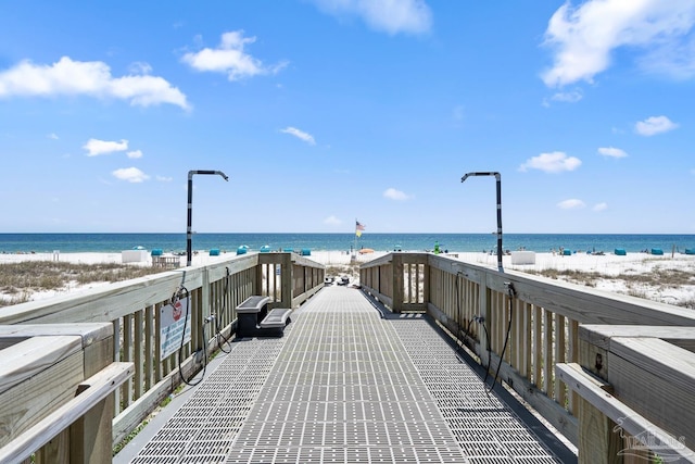 view of community with a beach view and a water view