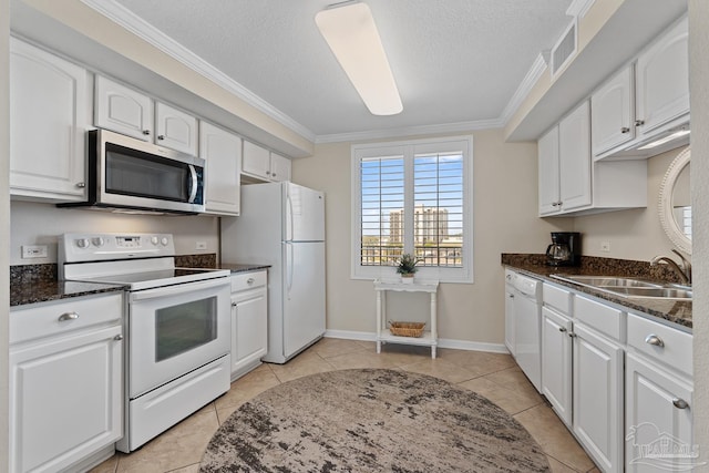 kitchen featuring white cabinetry, white appliances, ornamental molding, and dark stone countertops