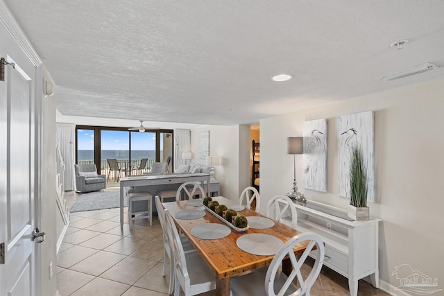 dining space with light tile patterned floors and a textured ceiling