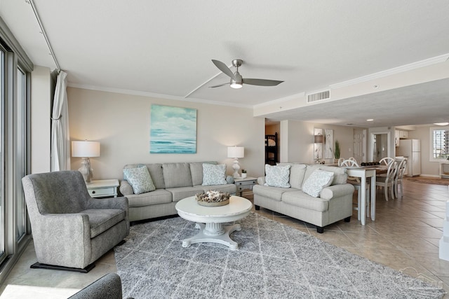 living room featuring light tile patterned flooring, ceiling fan, and ornamental molding