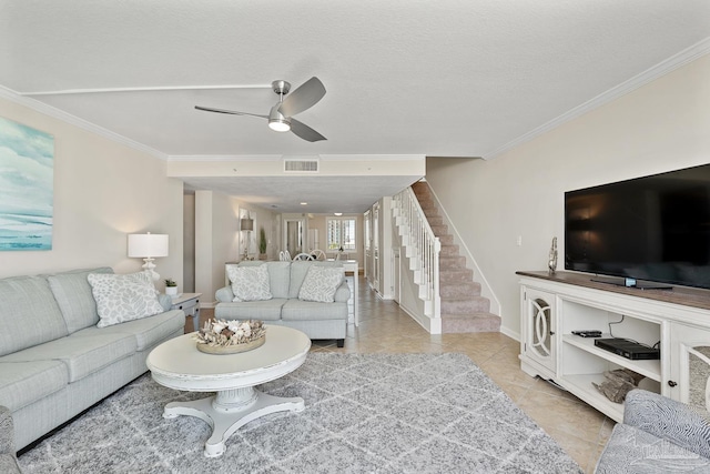 living room featuring ornamental molding, light tile patterned floors, and ceiling fan