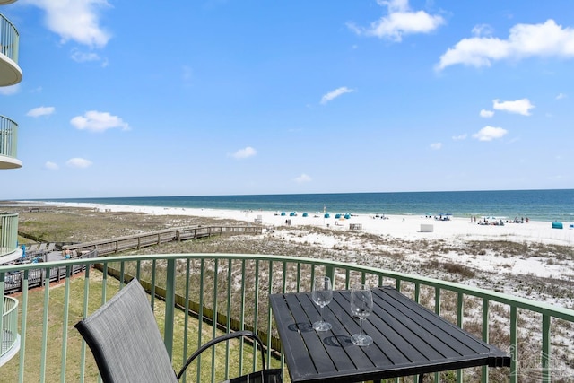 balcony featuring a beach view and a water view