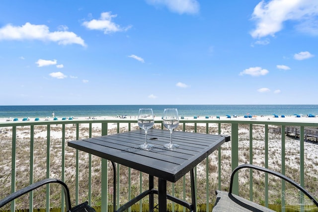 balcony with a water view and a beach view