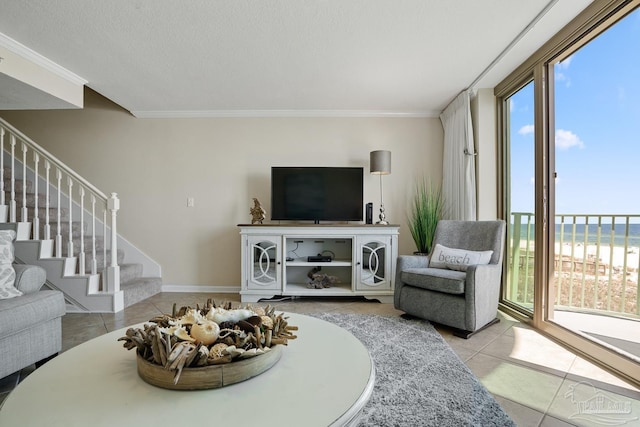 living room with crown molding, a textured ceiling, and light tile patterned flooring