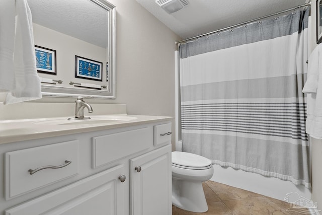 full bathroom featuring toilet, shower / tub combo, a textured ceiling, vanity, and tile patterned flooring