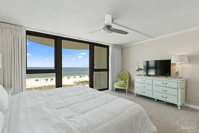 bedroom featuring ceiling fan, crown molding, light colored carpet, and a textured ceiling