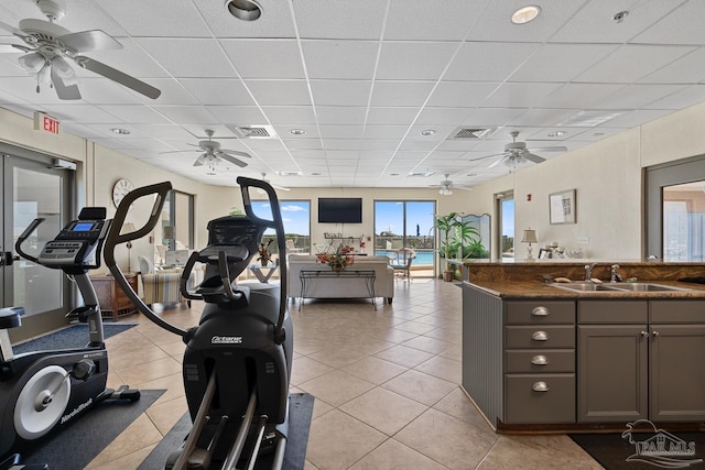 interior space featuring sink, a paneled ceiling, ceiling fan, and light tile patterned flooring