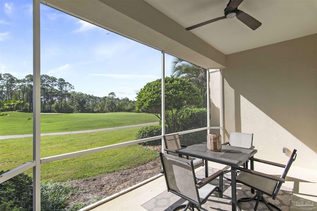 sunroom featuring a ceiling fan