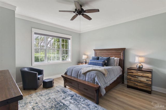 bedroom with baseboards, ornamental molding, ceiling fan, and wood finished floors