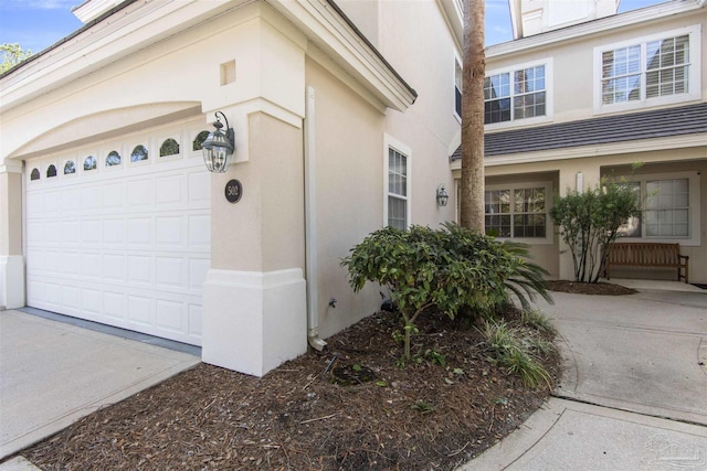 garage with concrete driveway