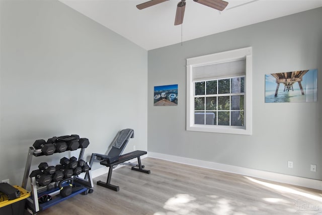 exercise room featuring wood finished floors, a ceiling fan, and baseboards