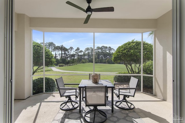 sunroom with plenty of natural light and a ceiling fan