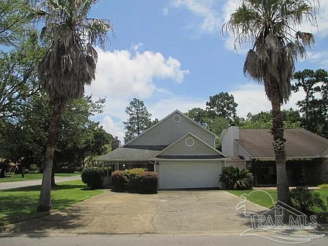 view of front of home featuring a garage, a front yard, and concrete driveway