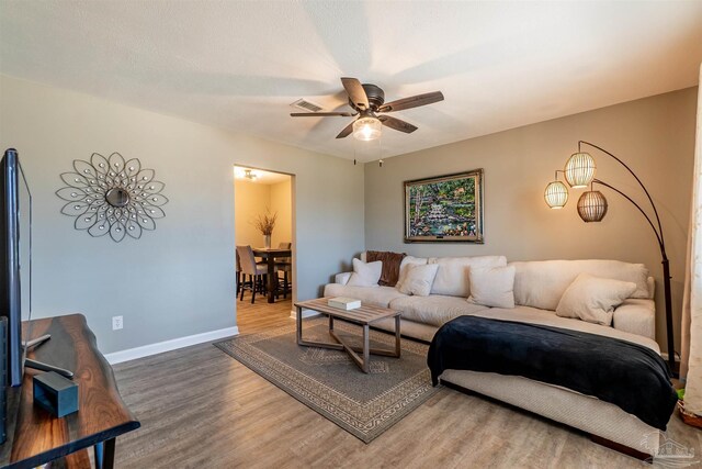 5518 Cyanamid Rd, Milton, FL 32583 - living area featuring wood finished floors, ceiling fan, and baseboards