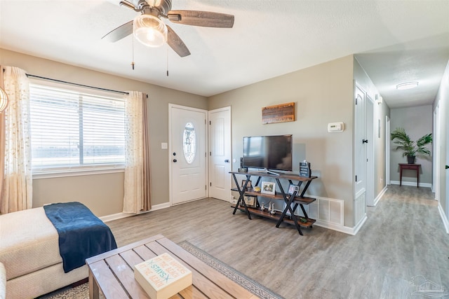 5518 Cyanamid Rd, Milton, FL 32583 - living room with wood finished floors, baseboards, and a ceiling fan