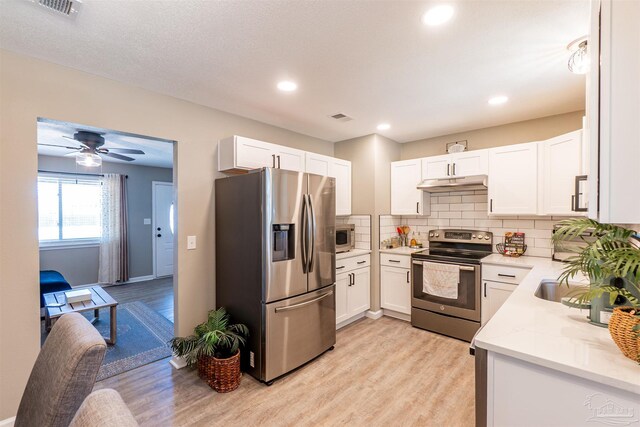 5518 Cyanamid Rd, Milton, FL 32583 - kitchen with appliances with stainless steel finishes, under cabinet range hood, light wood-style flooring, backsplash, and recessed lighting