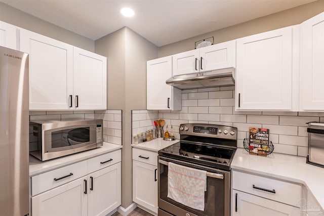 5518 Cyanamid Rd, Milton, FL 32583 - kitchen featuring appliances with stainless steel finishes, under cabinet range hood, light countertops, backsplash, and white cabinets