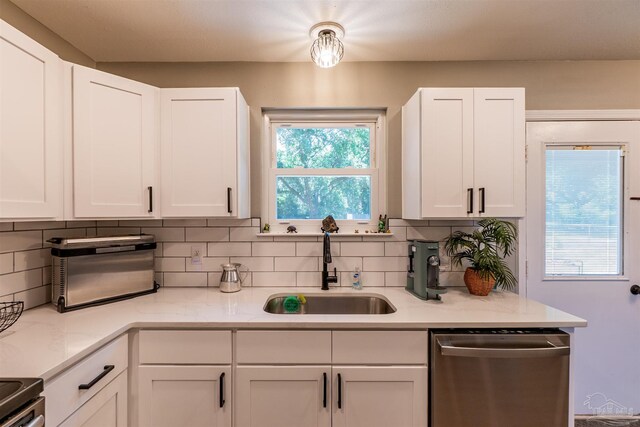 5518 Cyanamid Rd, Milton, FL 32583 - kitchen with appliances with stainless steel finishes, a sink, tasteful backsplash, and white cabinetry
