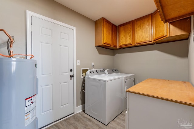 5518 Cyanamid Rd, Milton, FL 32583 - clothes washing area with cabinet space, electric water heater, washing machine and clothes dryer, and light wood-type flooring