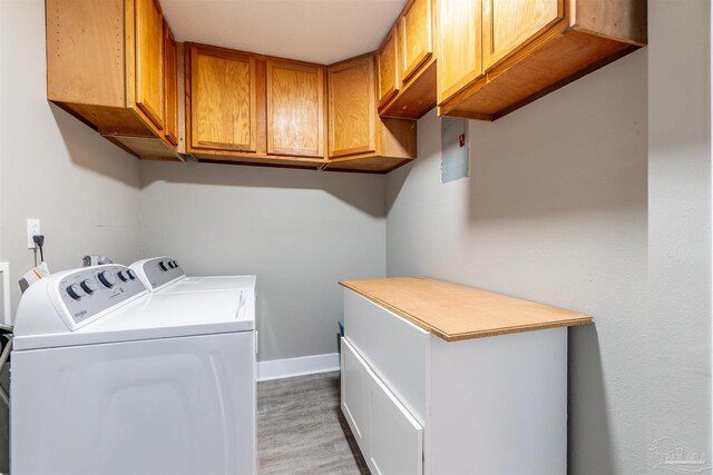 5518 Cyanamid Rd, Milton, FL 32583 - laundry area with cabinet space, separate washer and dryer, light wood finished floors, and baseboards