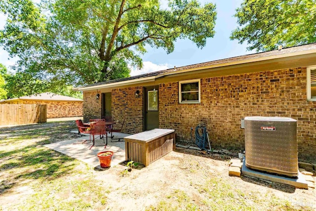 5518 Cyanamid Rd, Milton, FL 32583 - back of property featuring central AC unit, fence, brick siding, and a patio