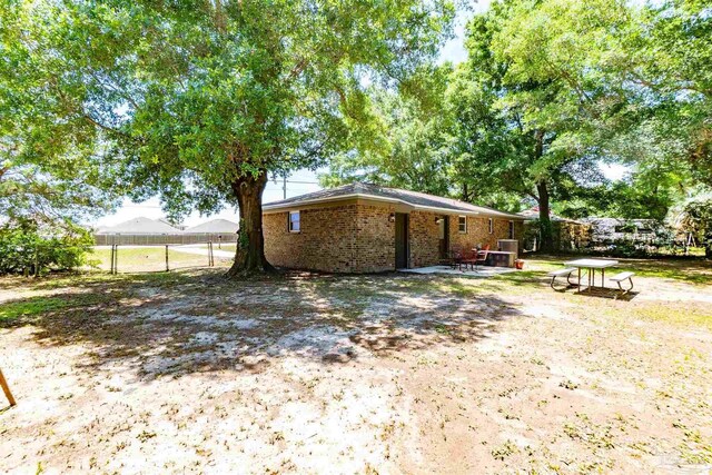 5518 Cyanamid Rd, Milton, FL 32583 - rear view of house featuring fence and brick siding