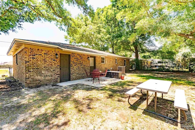 5518 Cyanamid Rd, Milton, FL 32583 - rear view of property with a patio area, brick siding, central AC unit, and fence