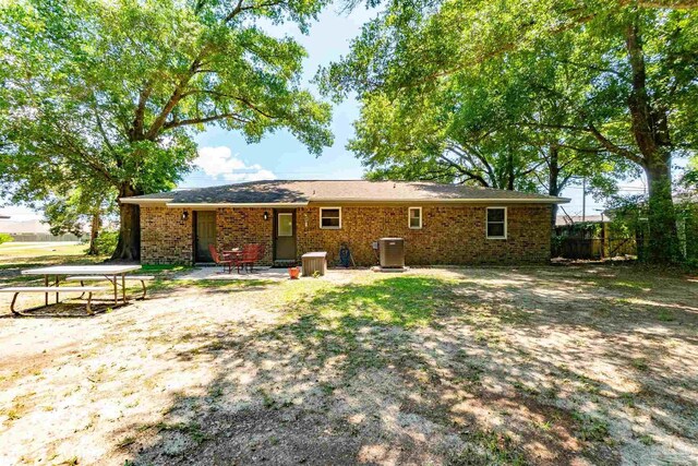 5518 Cyanamid Rd, Milton, FL 32583 - rear view of house with cooling unit, brick siding, and fence