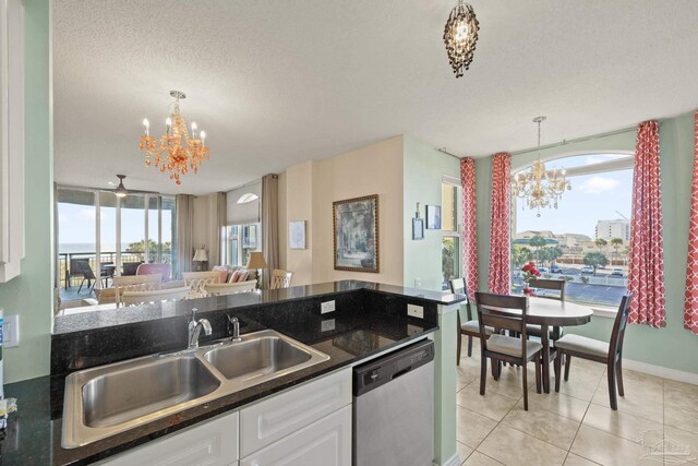 kitchen with white cabinets, stainless steel dishwasher, a healthy amount of sunlight, and sink