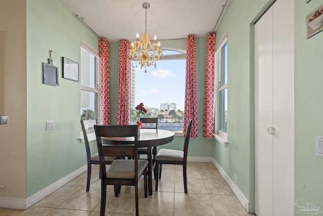 tiled dining space with a chandelier