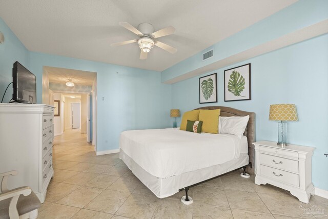 bedroom with ceiling fan and light tile patterned flooring