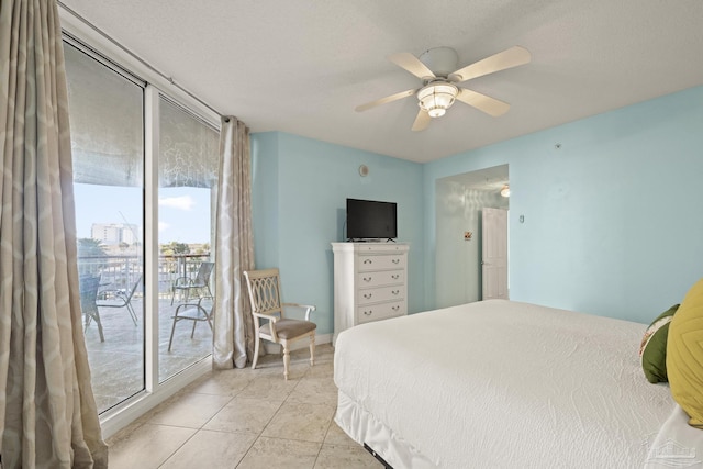 tiled bedroom featuring access to outside, ceiling fan, and a textured ceiling