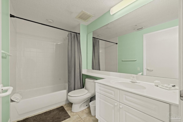 full bathroom featuring vanity, tile patterned flooring, toilet, shower / bath combo with shower curtain, and a textured ceiling